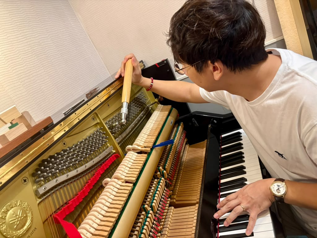 Timothy tuning an upright piano